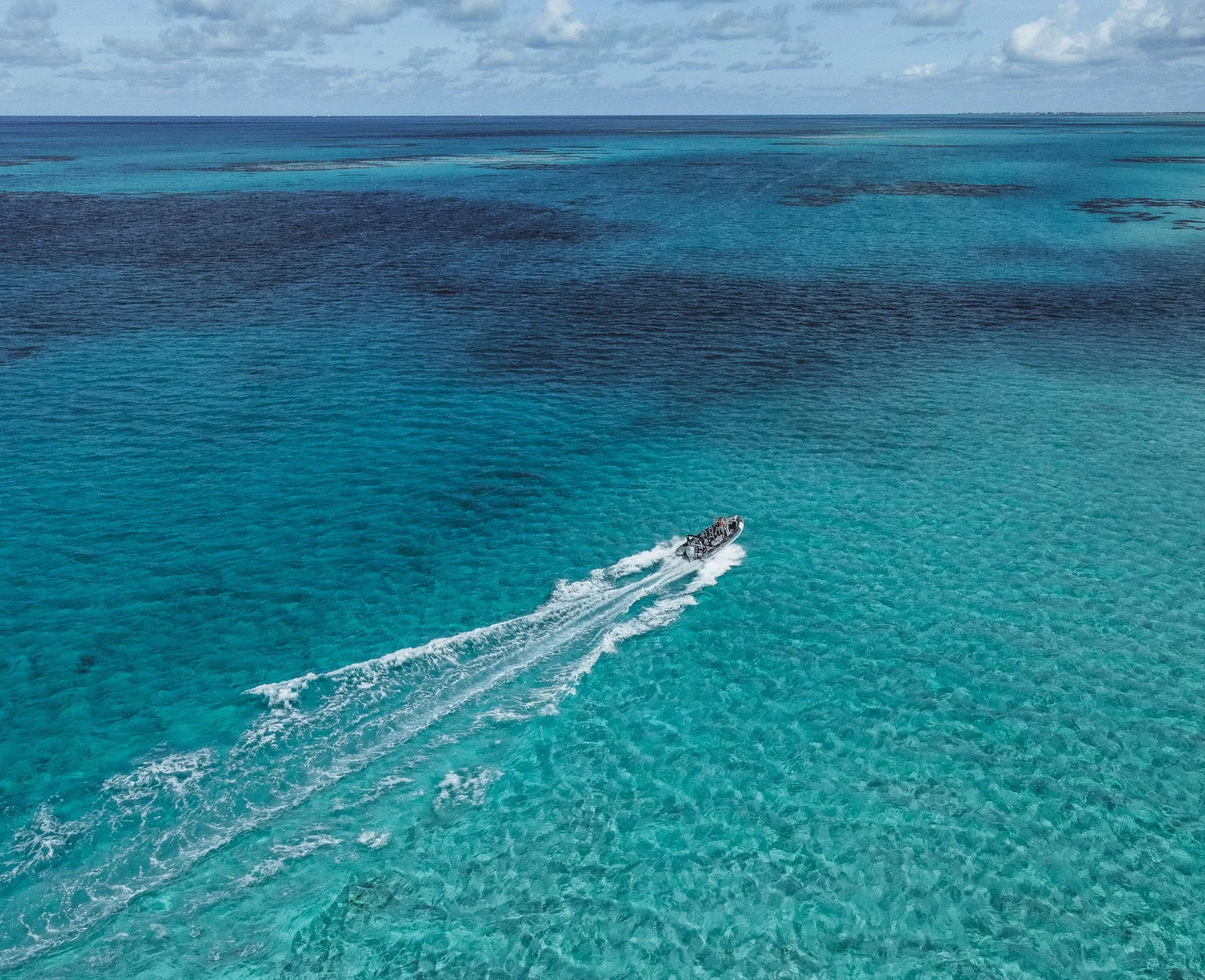 The RIB heading out across the flats, from above