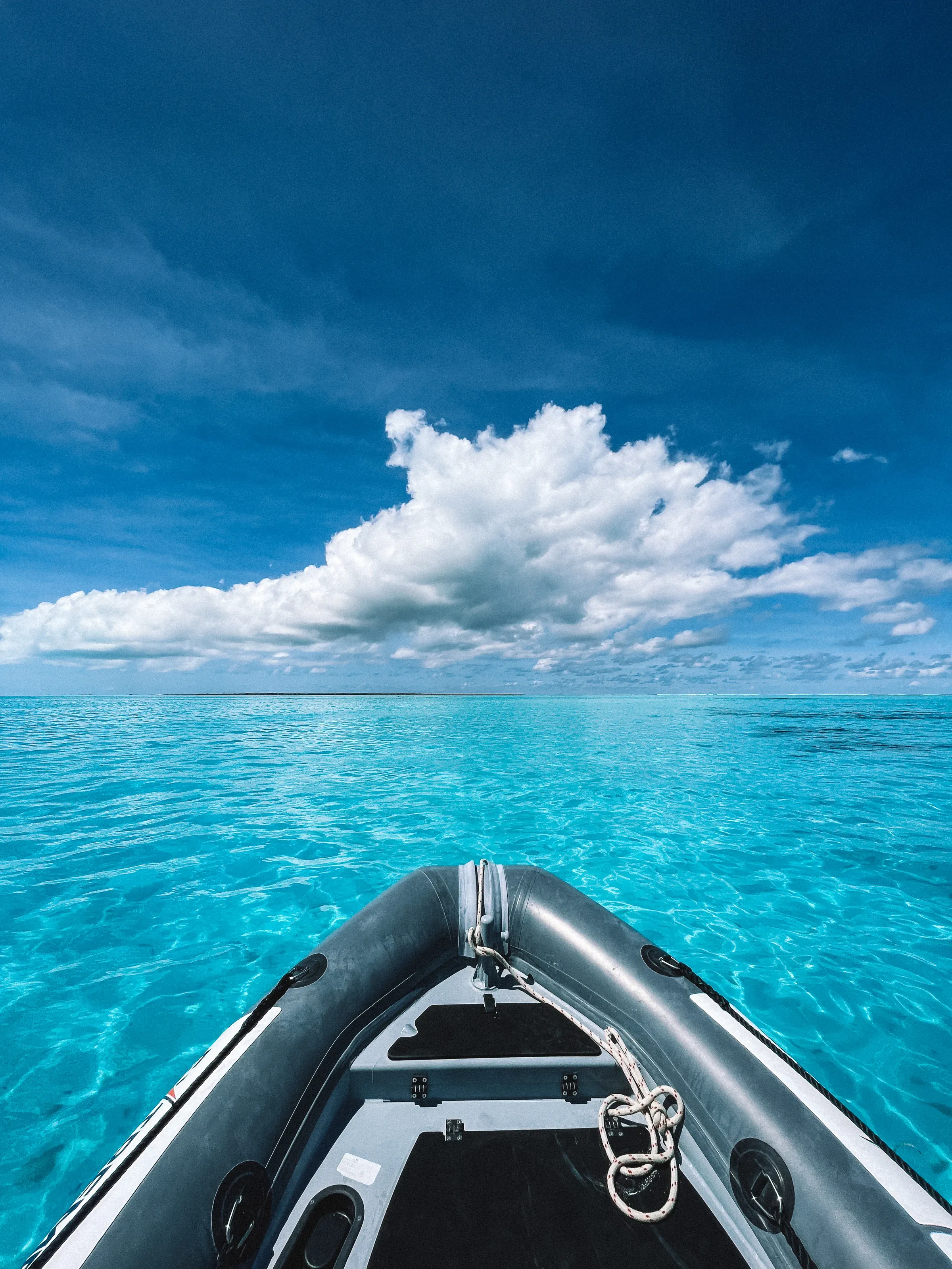 The bow of the RIB over clear water