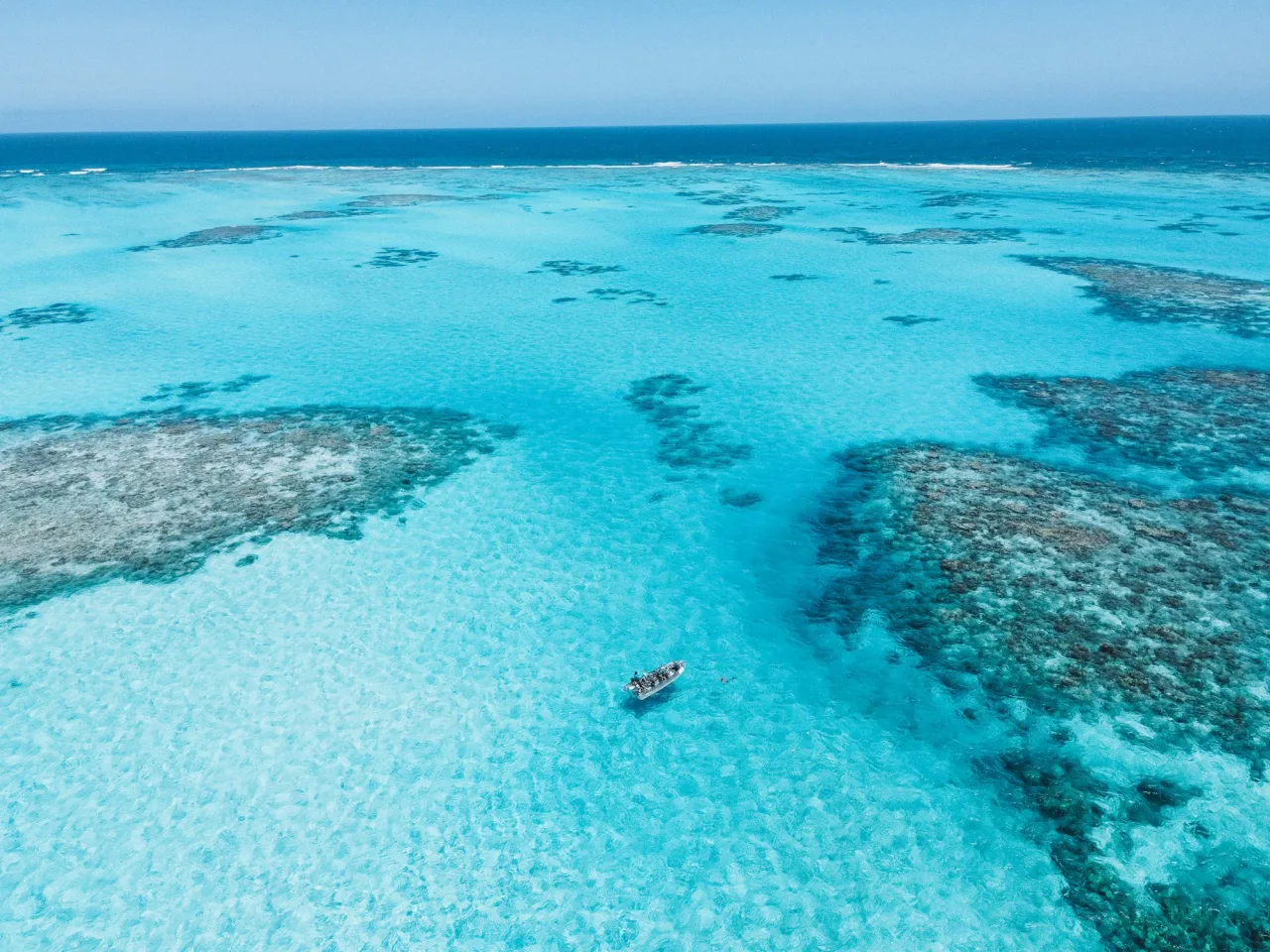 Horseshoe Reef from the air, the boat on the turquoise flats between the coral heads